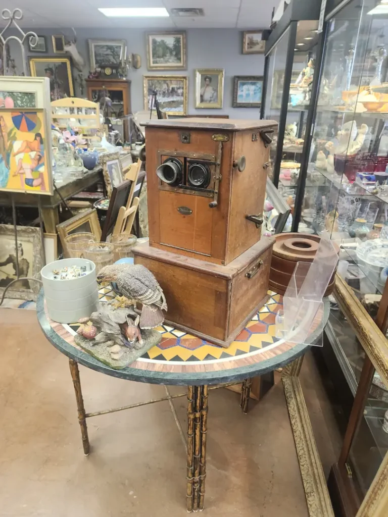 Antique wooden camera setup on a patterned round table surrounded by Southwest collectibles and treasures at Red Coyote Trading Post in Ft. Mohave, AZ.