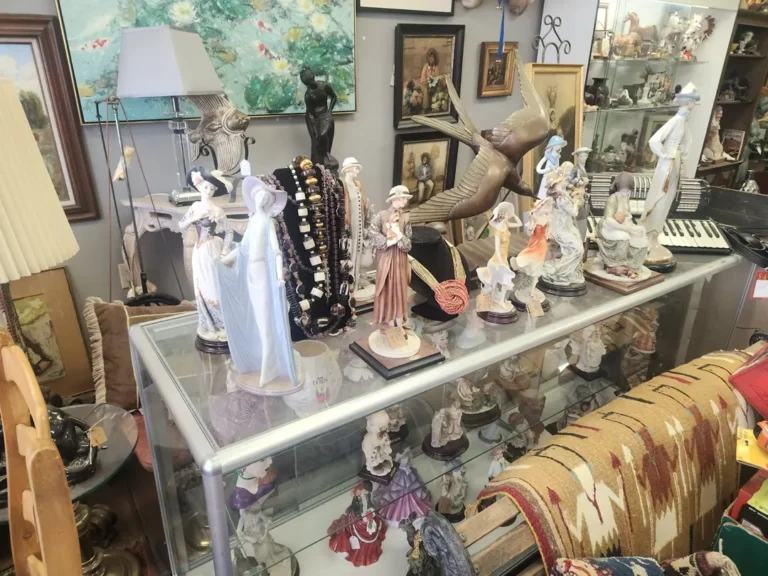 Display case with porcelain figurines and handcrafted beadwork