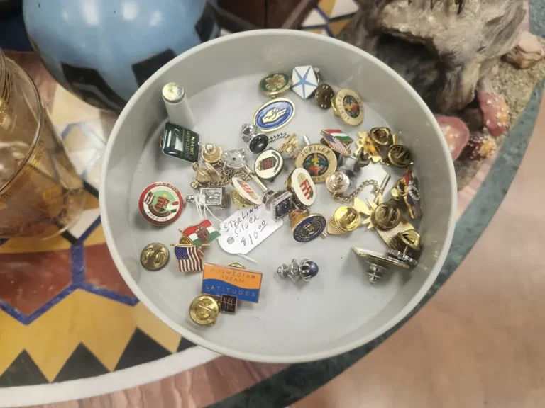 White dish displaying assorted collectible coins