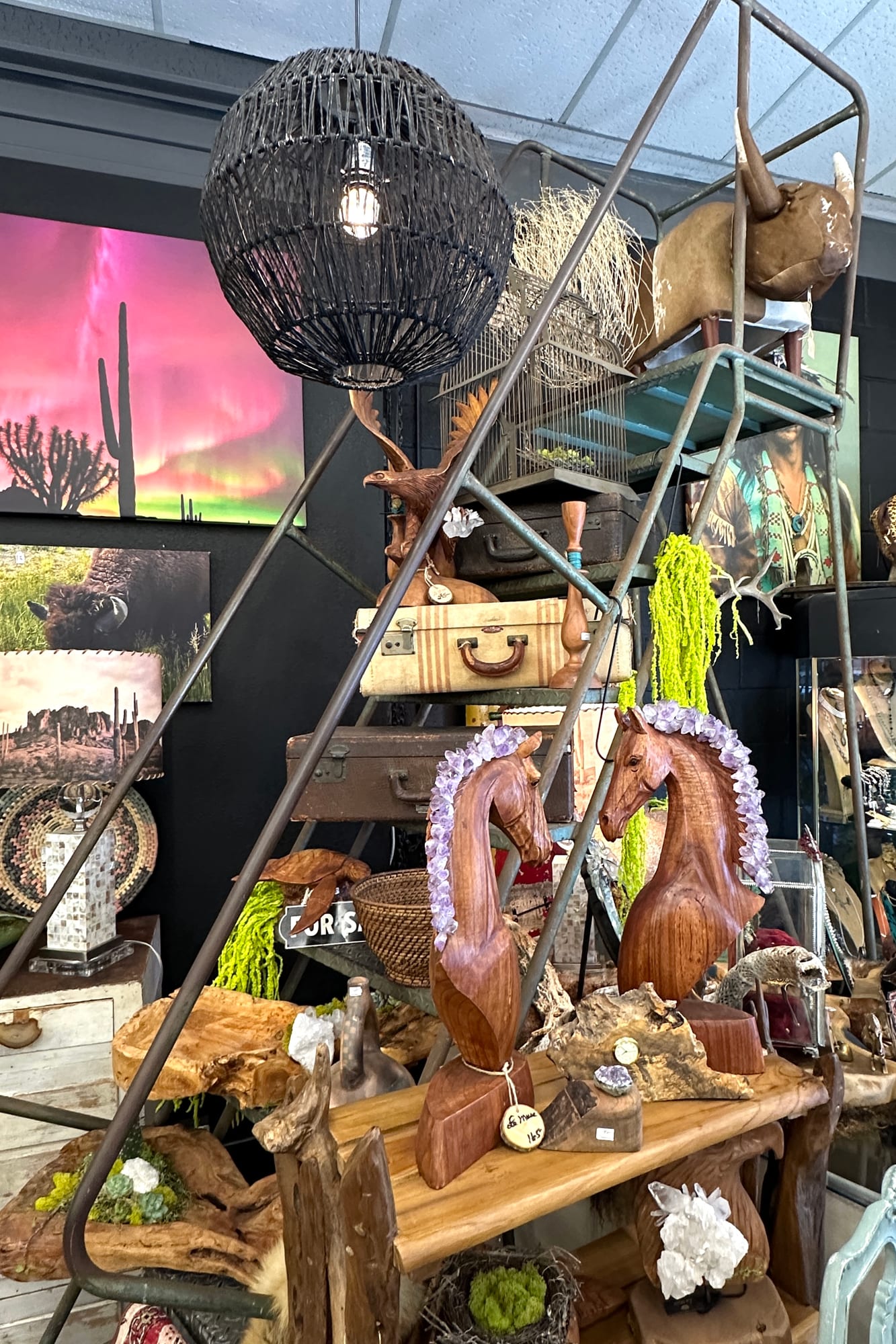 Rustic metal shelving with curated antique decor at Red Coyote